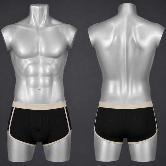 Front and back views of men's black ribbed boxer briefs with beige trim, displayed on silver male mannequins against a dark gray background.