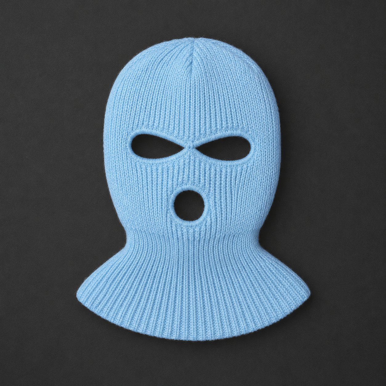 A light blue ribbed knit balaclava mask with eye and mouth cutouts, displayed against a dark gray background.